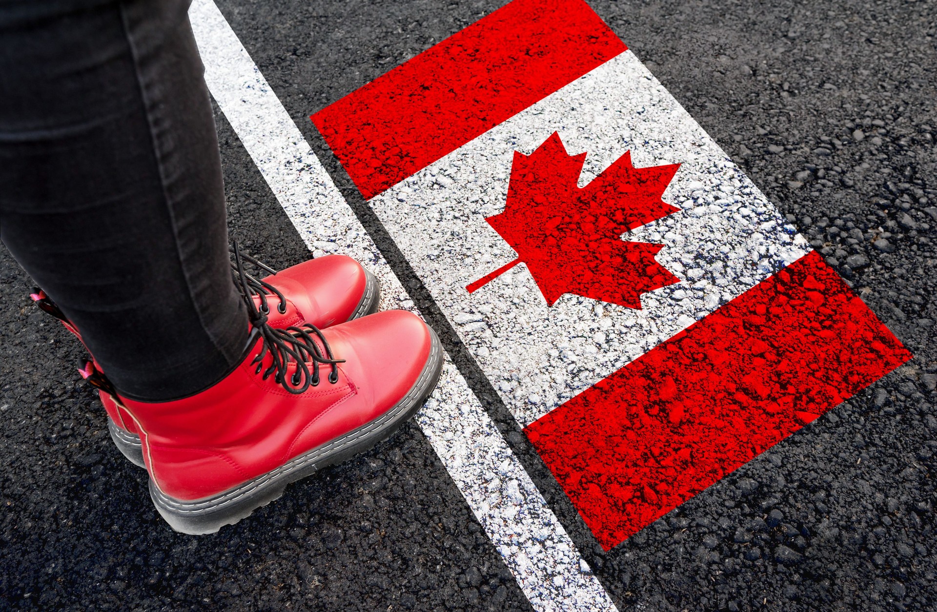 a woman  standing  next to flag of Canada